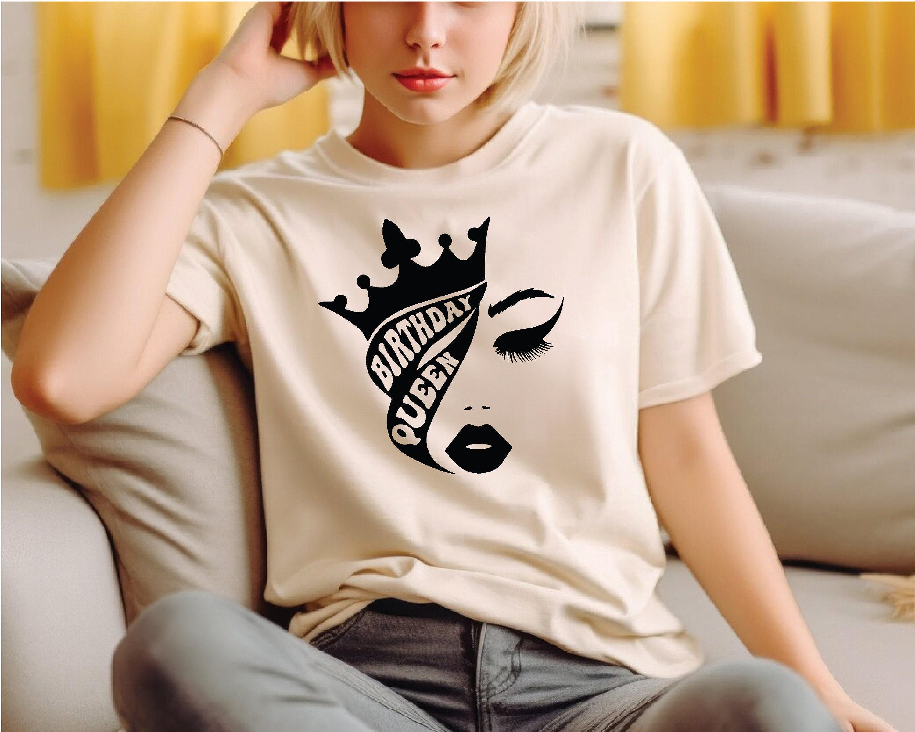 a woman sitting on a couch wearing a t - shirt
