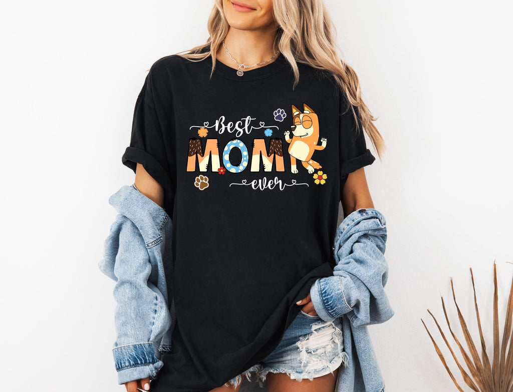 a woman wearing a black best mom shirt
