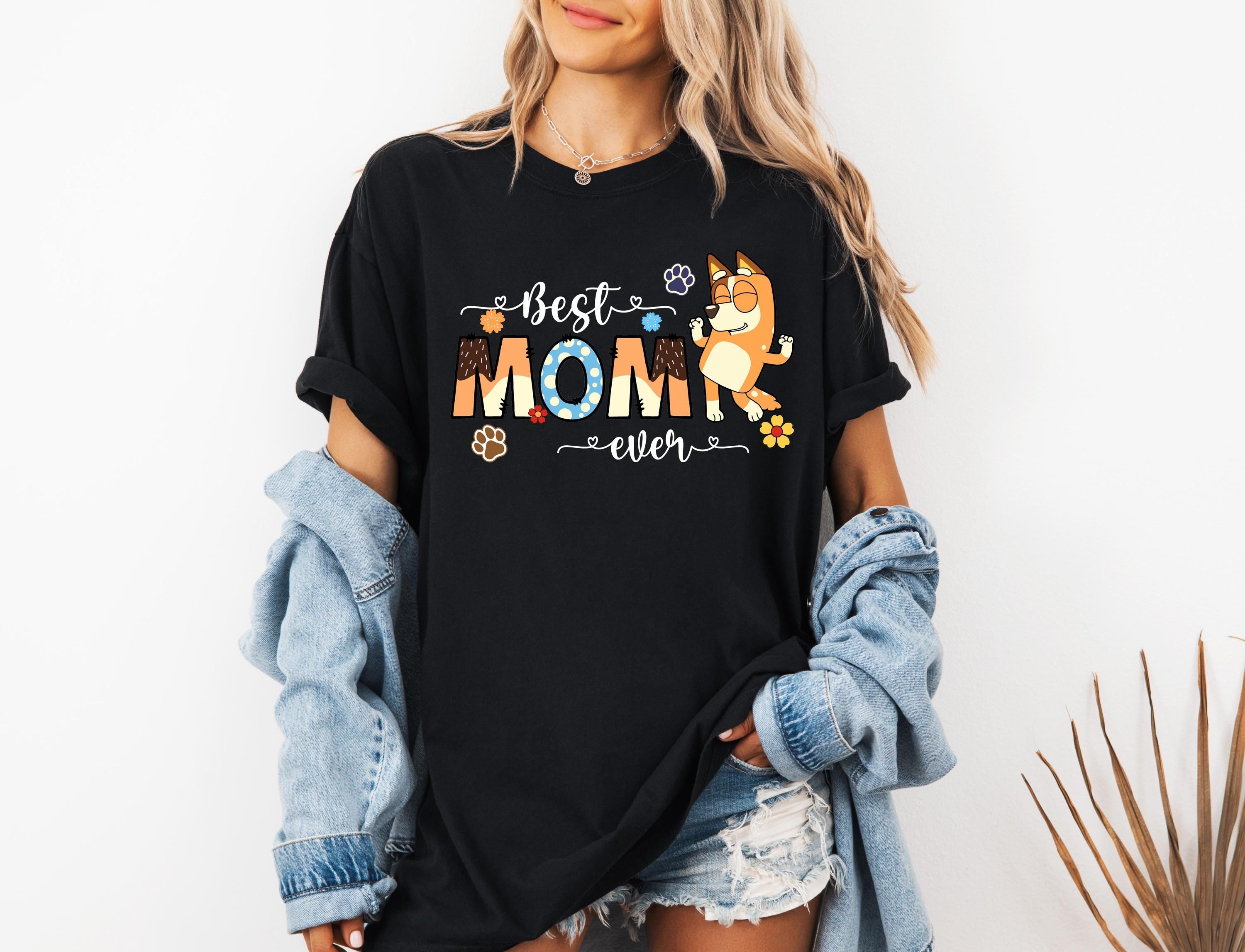 a woman wearing a black best mom shirt