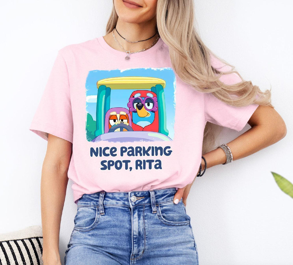 a woman wearing a pink t - shirt that says nice parking spot, ritz