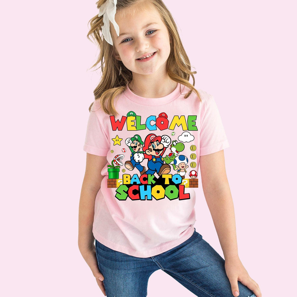 a young girl wearing a welcome to school shirt