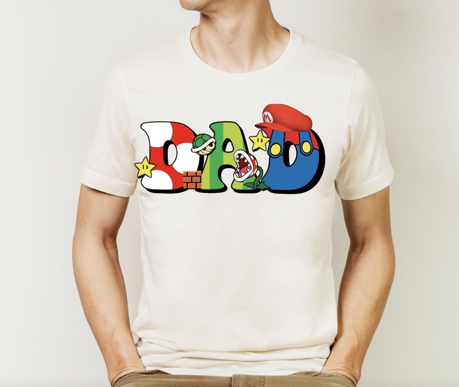 a man wearing a white t - shirt with the word mario printed on it