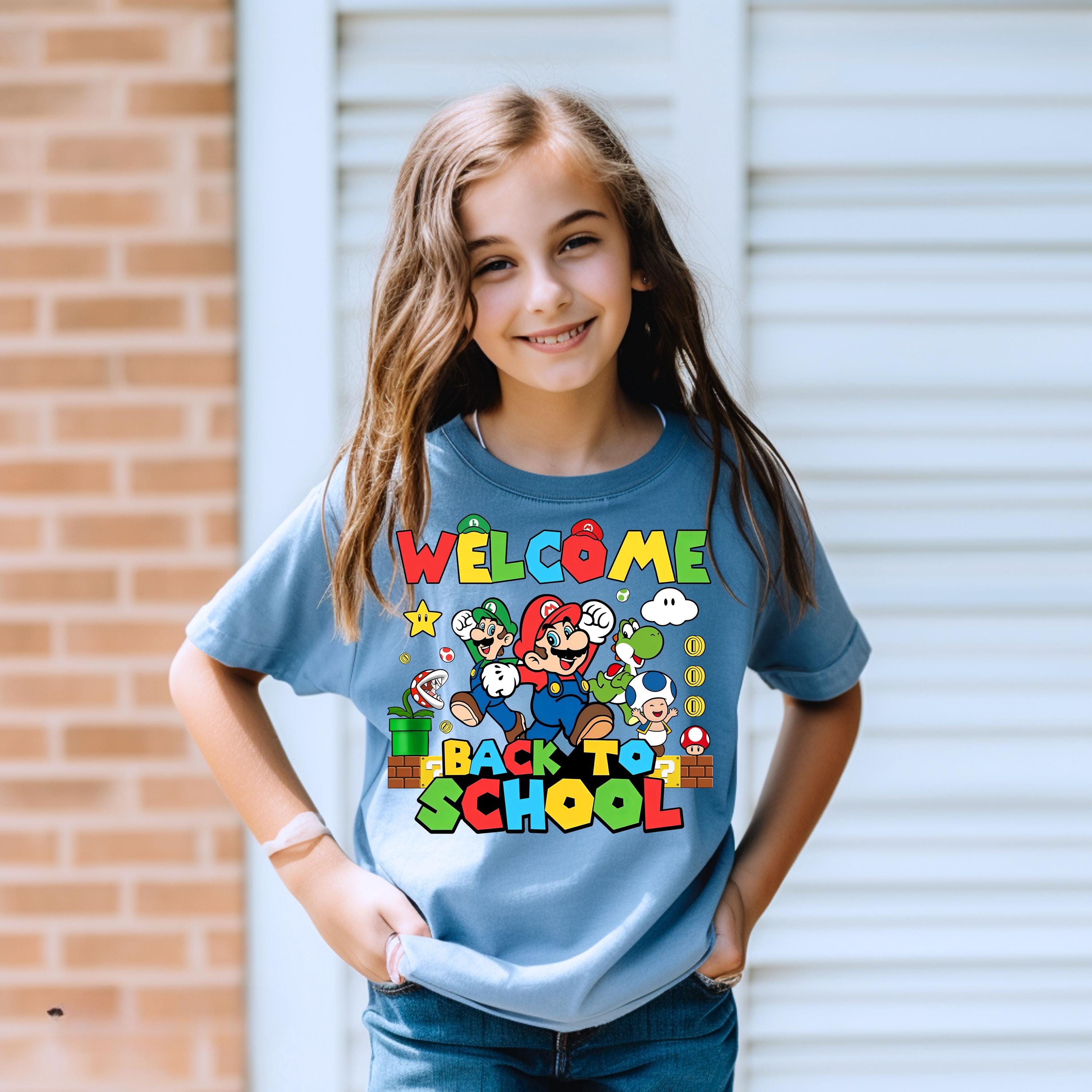 a young girl wearing a welcome back to school shirt