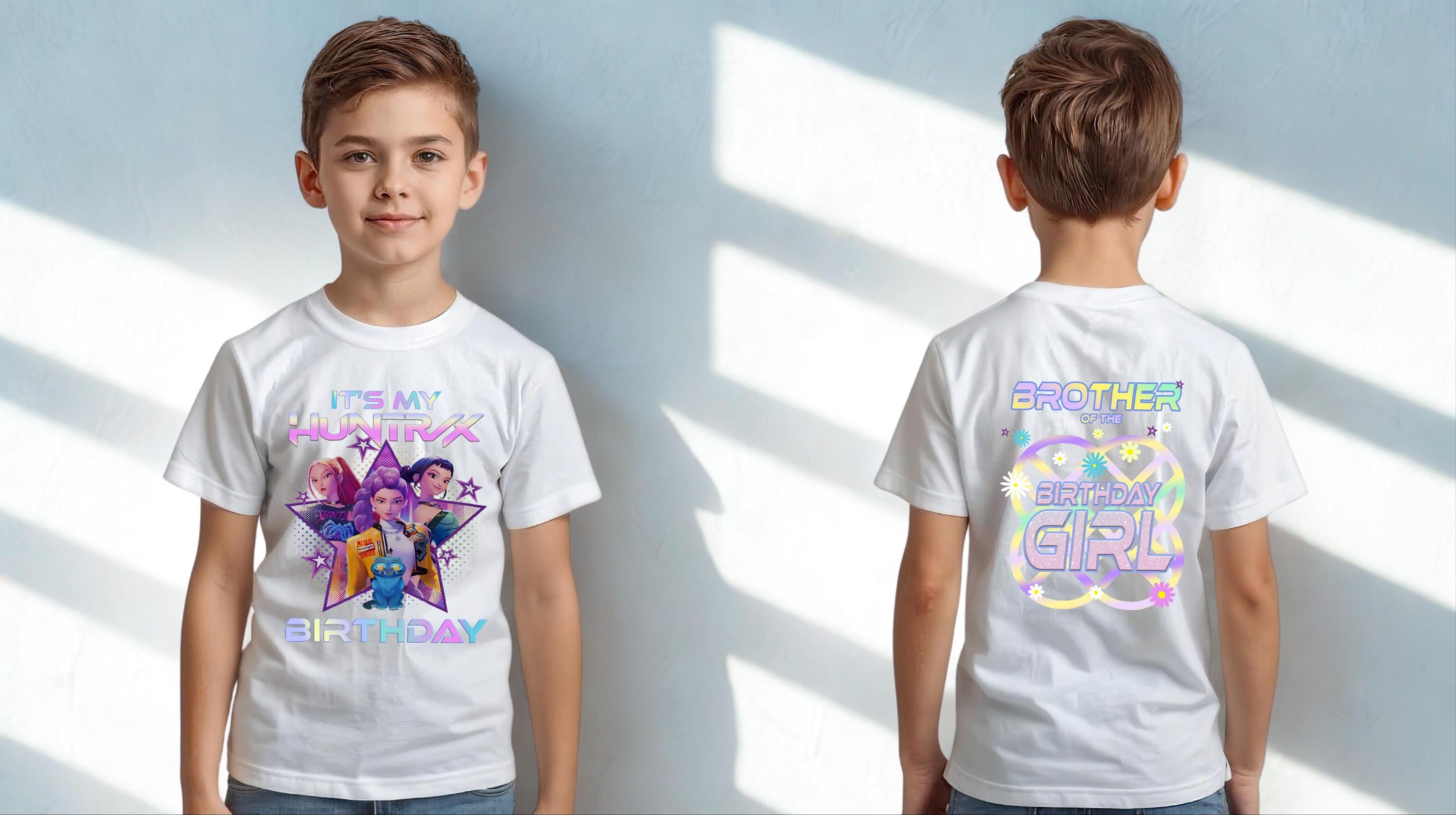 A young boy wearing a white t-shirt with a colorful graphic and text on it.