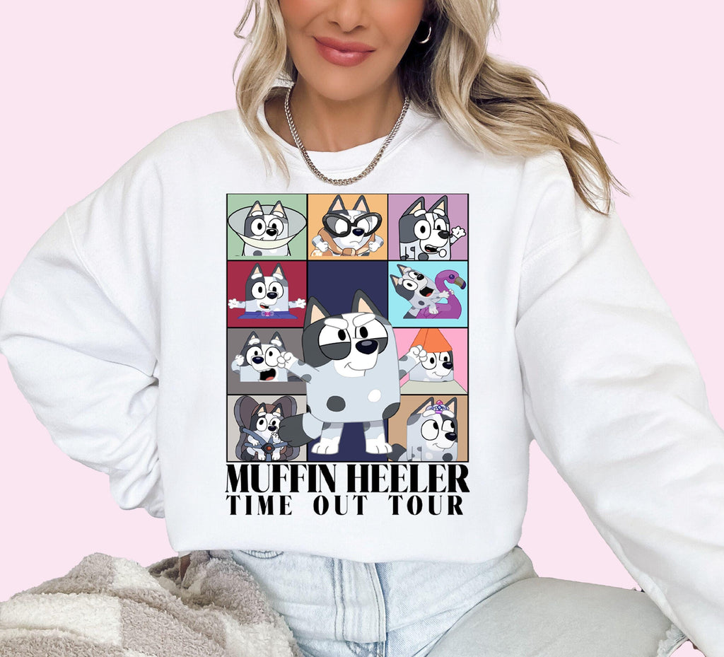 a woman wearing a white sweatshirt with cartoon characters on it